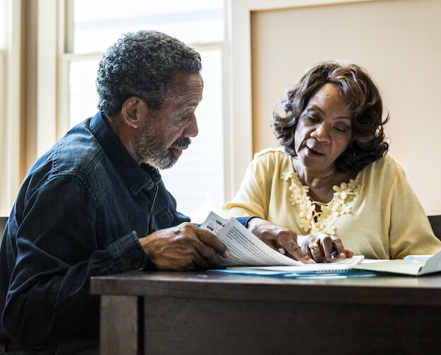 Senior couple paying bills at home